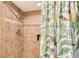 Walk-in shower features designer tile and a patterned shower curtain at 5855 Midnight Pass Rd # 512, Sarasota, FL 34242