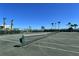 Well-maintained tennis court with palm trees around the perimeter for an active lifestyle at 5855 Midnight Pass Rd # 512, Sarasota, FL 34242