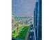 This view from the balcony reveals lush green landscaping and a glimpse of the waterfront beyond at 5855 Midnight Pass Rd # 512, Sarasota, FL 34242
