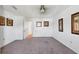 This bedroom features neutral carpet, white walls, ceiling fan, and closet at 6047 Arlene Way, Bradenton, FL 34207