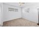 This bedroom features neutral carpet, white walls, ceiling fan, and a window at 6047 Arlene Way, Bradenton, FL 34207