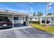Street view of a single story home with a carport, well-kept lawn and driveway with parked cars at 6047 Arlene Way, Bradenton, FL 34207