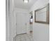 Entryway with tiled floor and mirrored accent wall near kitchen at 6047 Arlene Way, Bradenton, FL 34207