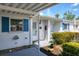 Charming single-story home featuring white siding, blue shutters and a well-maintained front garden at 6047 Arlene Way, Bradenton, FL 34207