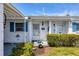 Charming single-story home featuring white siding, blue shutters and a well-maintained front garden at 6047 Arlene Way, Bradenton, FL 34207