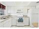 Clean kitchen equipped with white appliances and functional layout at 6047 Arlene Way, Bradenton, FL 34207