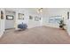 Spacious living room features neutral carpet, white walls, a ceiling fan, and natural light at 6047 Arlene Way, Bradenton, FL 34207