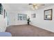 Bright living room featuring neutral carpet, white walls, ceiling fan and natural light at 6047 Arlene Way, Bradenton, FL 34207