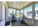 Enclosed sunroom with two chairs and multiple large windows at 6047 Arlene Way, Bradenton, FL 34207