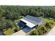 Aerial view showcasing the pool, screened lanai, carport, and lush backyard of this lovely property at 6365 Jim Davis Rd, Parrish, FL 34219