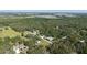 Overview of property with private pool, wooded area, outbuildings and multiple structures at 6365 Jim Davis Rd, Parrish, FL 34219