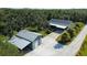 Aerial view of the property with a detached barn, and long driveway at 6365 Jim Davis Rd, Parrish, FL 34219