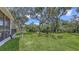 Spacious backyard with mature trees offering shade and privacy, perfect for outdoor activities and relaxation at 6365 Jim Davis Rd, Parrish, FL 34219
