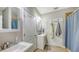 Bathroom has dual vanities, modern lighting fixtures, and a shower with tile accents at 6365 Jim Davis Rd, Parrish, FL 34219