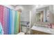 Functional bathroom with a bright shower curtain and vanity with sink at 6365 Jim Davis Rd, Parrish, FL 34219