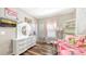 Charming bedroom featuring wood floors, decorative accents, and a sunny window at 6365 Jim Davis Rd, Parrish, FL 34219