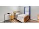 This bedroom features a wood frame bed, matching nightstand, and wood floors at 6365 Jim Davis Rd, Parrish, FL 34219