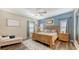 Comfortable bedroom with hardwood floors, ceiling fan, and natural light from the home's windows at 6365 Jim Davis Rd, Parrish, FL 34219