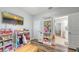 Bedroom area displays built-in shelves, television, wooden floors, and access to bathroom at 6365 Jim Davis Rd, Parrish, FL 34219