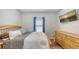 Bedroom showcases a wood frame bed, dresser, wood floors, and mounted television at 6365 Jim Davis Rd, Parrish, FL 34219