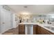 Spacious kitchen with granite counters, stainless steel appliances, and seamless flow to the dining and living area at 6365 Jim Davis Rd, Parrish, FL 34219