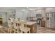 Open-concept kitchen featuring granite countertops, stainless steel appliances, and seamless access to the living area at 6365 Jim Davis Rd, Parrish, FL 34219