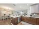 Open kitchen with granite island, modern appliances, and hardwood floors that overlook the living room at 6365 Jim Davis Rd, Parrish, FL 34219