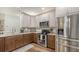 Modern kitchen featuring granite countertops, two-tone cabinets, and stainless steel appliances at 6365 Jim Davis Rd, Parrish, FL 34219