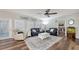 Cozy living room featuring neutral paint, a ceiling fan, plantation shutters and gray sofa at 6365 Jim Davis Rd, Parrish, FL 34219