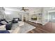 Spacious living room featuring built-in shelving, a ceiling fan, plantation shutters and gray sofa at 6365 Jim Davis Rd, Parrish, FL 34219