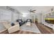 Bright living room featuring neutral paint, a ceiling fan, plantation shutters and gray sofa at 6365 Jim Davis Rd, Parrish, FL 34219