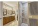 Bright main bathroom featuring double sinks and a tiled walk-in shower at 6365 Jim Davis Rd, Parrish, FL 34219