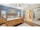 Bright main bedroom with blue accent wall, wood-look flooring, and lots of natural light at 6365 Jim Davis Rd, Parrish, FL 34219