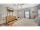 Cozy main bedroom with wood-look flooring, ceiling fan, and natural wood accents at 6365 Jim Davis Rd, Parrish, FL 34219