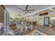 Relaxing screened porch featuring comfortable seating, dining area, and outdoor entertainment with a mounted television at 6365 Jim Davis Rd, Parrish, FL 34219