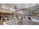 Cozy screened porch with plush seating overlooking a sparkling swimming pool and beautifully landscaped backyard at 6365 Jim Davis Rd, Parrish, FL 34219