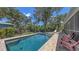 Inviting backyard pool and spa with brick surround, creating a perfect oasis for relaxation and outdoor enjoyment at 6365 Jim Davis Rd, Parrish, FL 34219