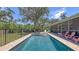 Beautiful backyard pool and spa with poolside seating, creating a serene and private outdoor retreat at 6365 Jim Davis Rd, Parrish, FL 34219