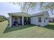 Picture of the house's rear, showing a well-maintained backyard with mature trees and screened patio at 6412 Golden Eye Gln, Lakewood Ranch, FL 34202