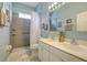 Bathroom featuring double sinks, a walk-in shower, and a privacy window at 6412 Golden Eye Gln, Lakewood Ranch, FL 34202