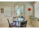 Bright breakfast nook featuring a glass table, chairs, and a sliding glass door at 6412 Golden Eye Gln, Lakewood Ranch, FL 34202