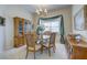 Dining room featuring a chandelier, window with decor, and wood furniture at 6412 Golden Eye Gln, Lakewood Ranch, FL 34202