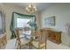 Dining room featuring a chandelier, window with decor, and wood furniture at 6412 Golden Eye Gln, Lakewood Ranch, FL 34202