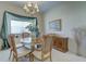 Dining room featuring a chandelier, window with decor, and wood furniture at 6412 Golden Eye Gln, Lakewood Ranch, FL 34202