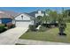 This is an aerial view of a beautiful home with a well-manicured lawn and a two-car garage at 6412 Golden Eye Gln, Lakewood Ranch, FL 34202