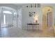 Inviting foyer with tile floors, arched doorways, neutral paint, and decorative shelving above a white wall at 6412 Golden Eye Gln, Lakewood Ranch, FL 34202