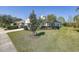 Well-manicured front yard with lush landscaping, mature trees, and a glimpse of the house exterior at 6412 Golden Eye Gln, Lakewood Ranch, FL 34202