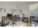 Home office with desk space, large window, sofa, and neutral walls at 6412 Golden Eye Gln, Lakewood Ranch, FL 34202