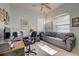 Home office with desk space, large window, sofa, and neutral walls at 6412 Golden Eye Gln, Lakewood Ranch, FL 34202
