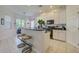 Bright kitchen featuring white cabinets, tile floors, and a breakfast bar with seating at 6412 Golden Eye Gln, Lakewood Ranch, FL 34202